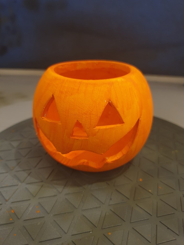 Orange painted ceramic pumpkin tealight holder for Halloween crafts for your home. 