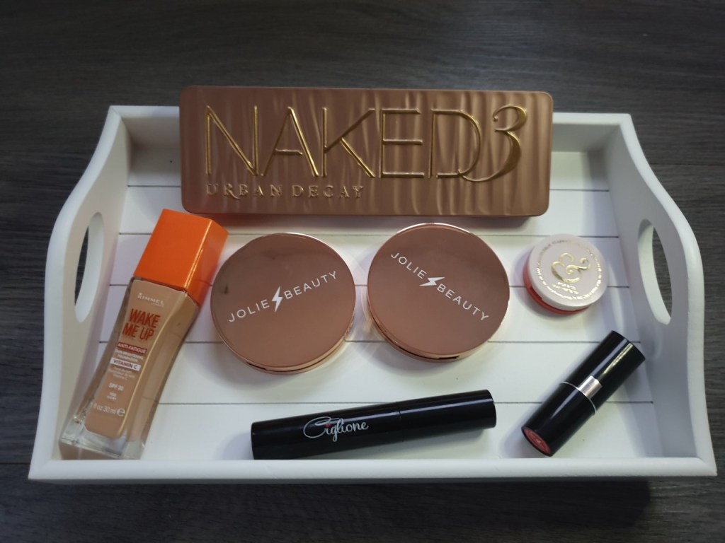 Festive Make Up Products Flatlay on a white wooden tray.
