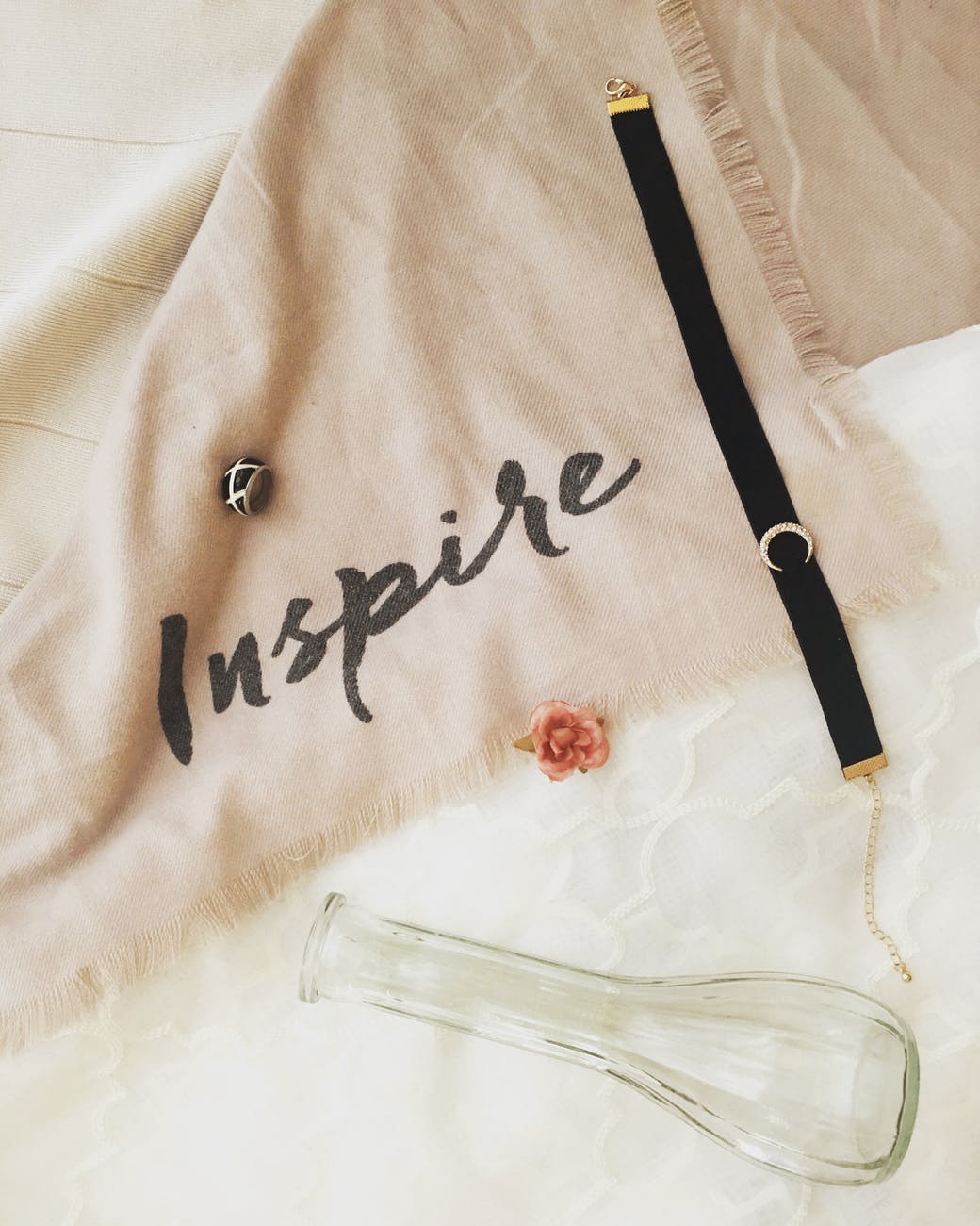 black choker on beige scarf with the word inspire written for tips for achieving your goals post.