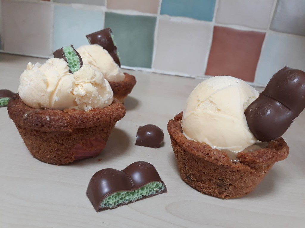 Mint aero cookie cups with mint aero chunks next to it on kitchen side