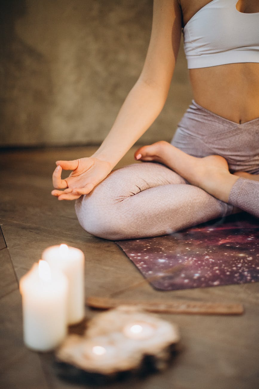 meditating with candles and incense with sustainable yoga mat