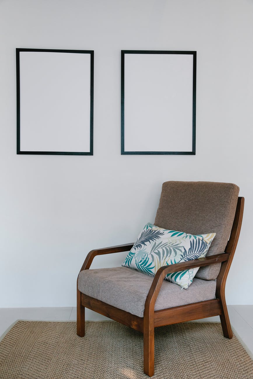 cozy armchair with pillow in light room