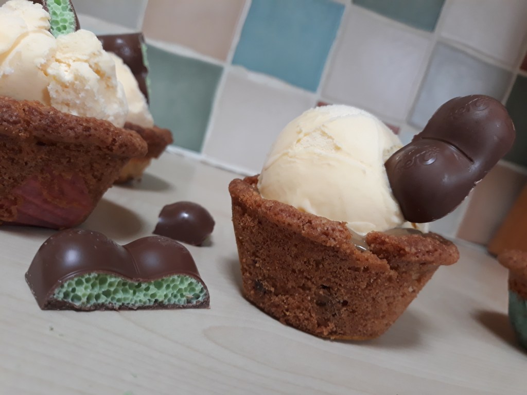 Mint aero cookie cups with mint aero chunks next to it on kitchen side