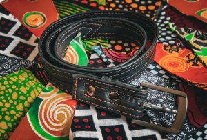 Christmas gift guide belt from Cycle Of Good with multi coloured bunting in the background