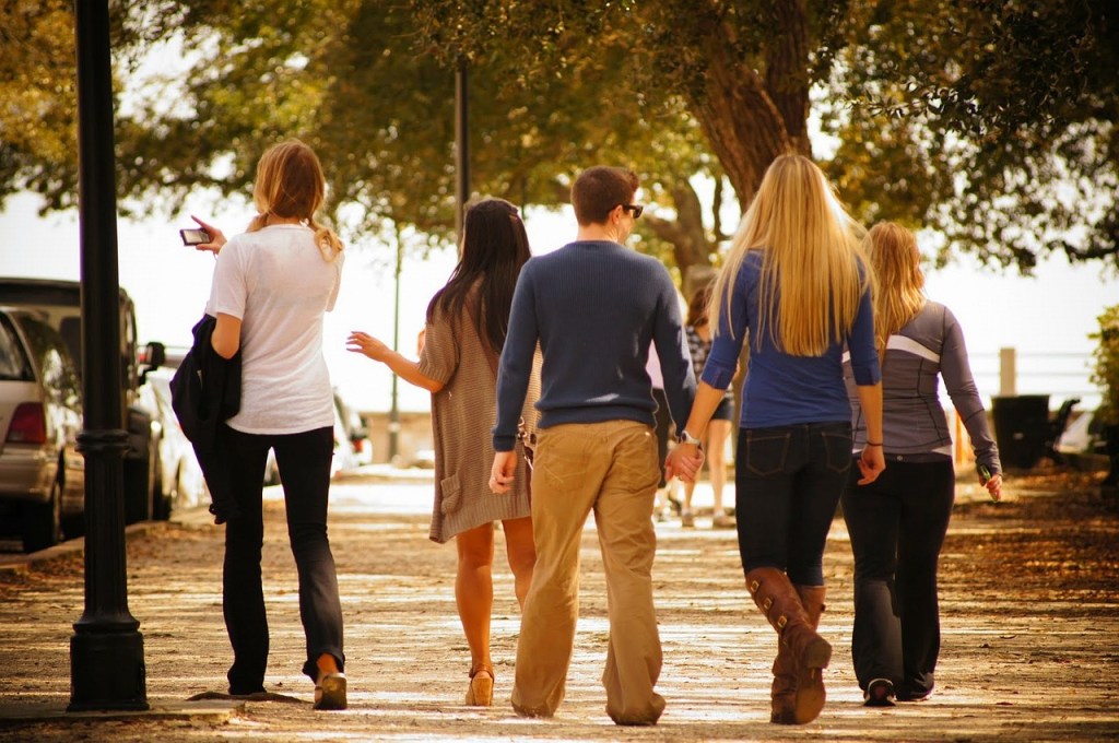 Group of people walking down the street for enjoying life in the fast-paced modern world post.