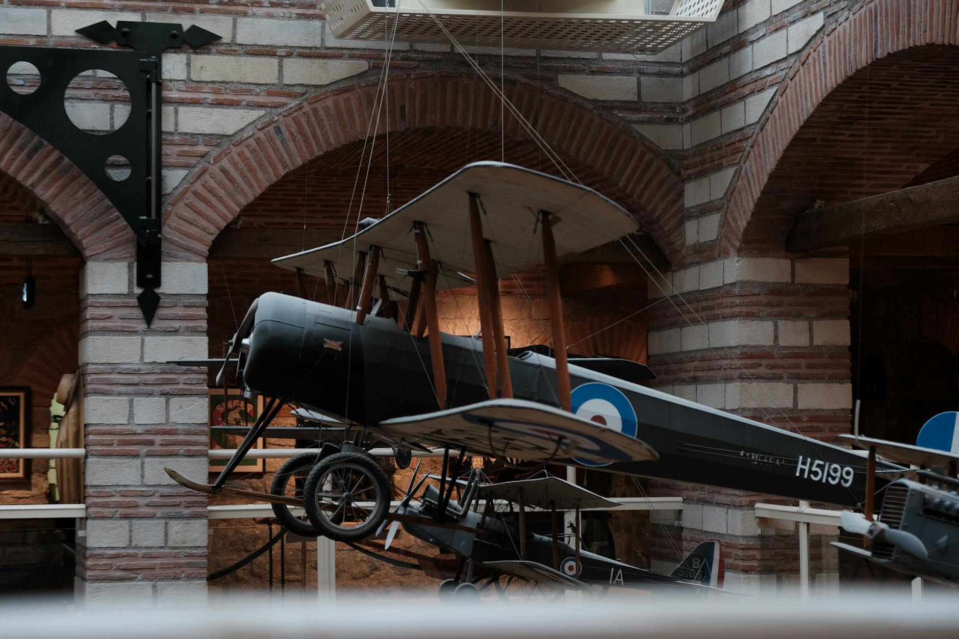 top 5 aviation museums in England showing an ww1 bi-plane in a museum setting.