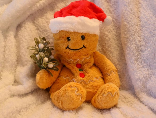 Gingerbread man holding mistletoe for Top Gift Ideas for Kids: A Complete Guide post.