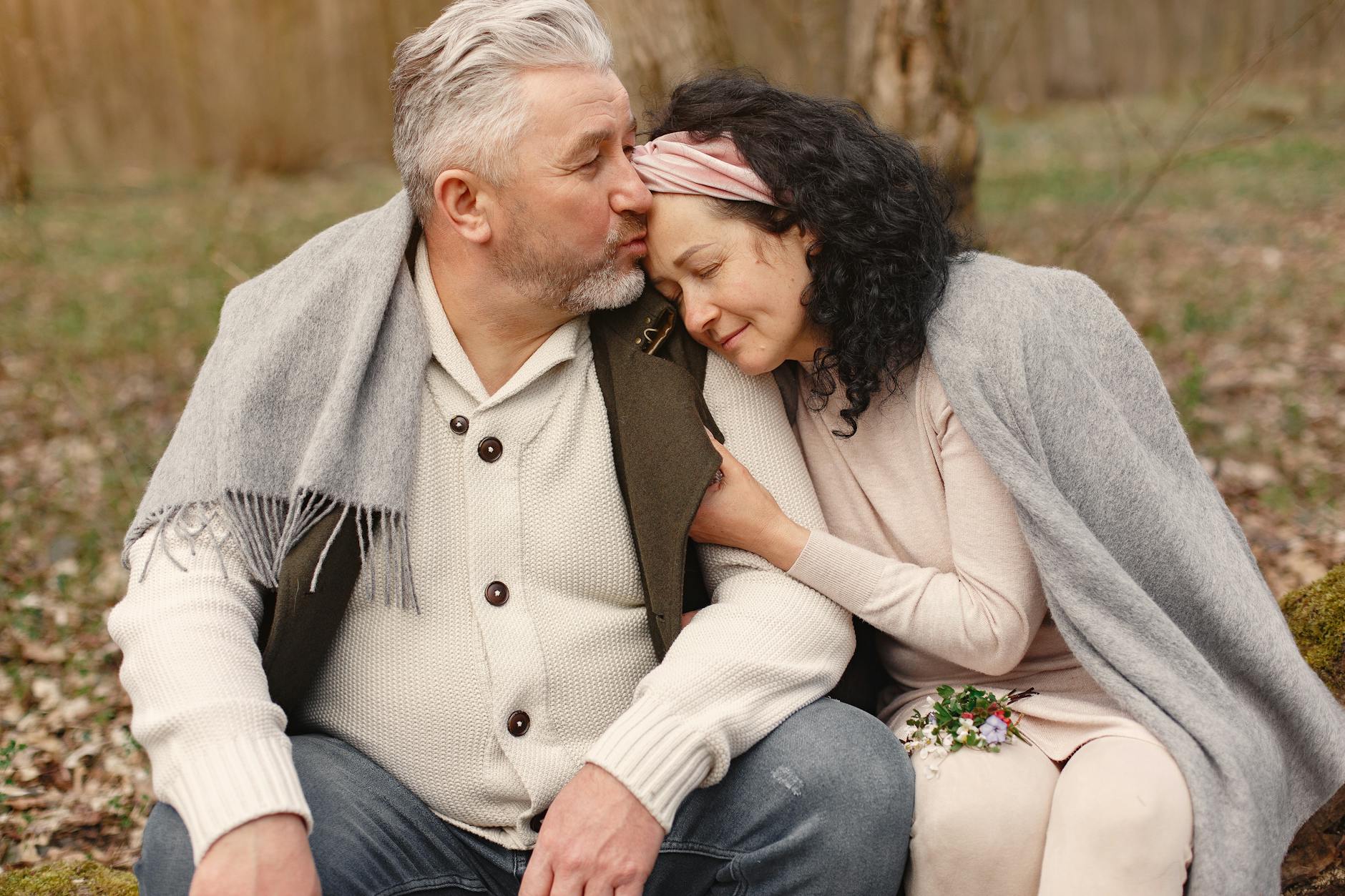 Couple sat in woodland for your ultimate gift guide for loved ones with dementia post.