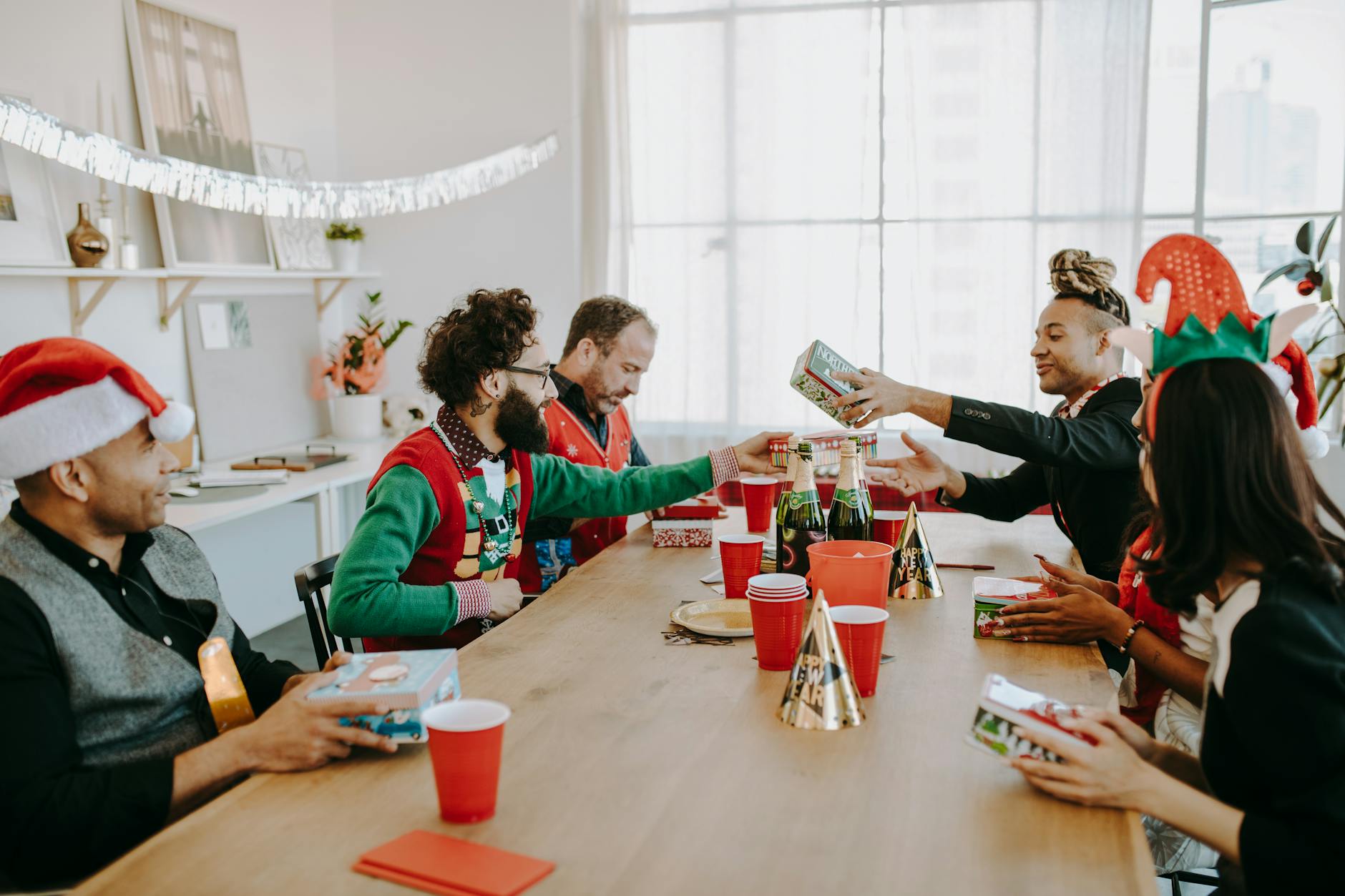 People sat round a tablet dressed festively for Your Ultimate Gift Guide for Loved Ones with Dementia post.