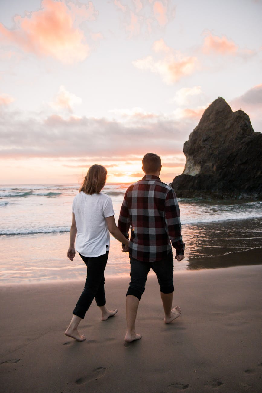 Couple walking on a beach for Date Night Ideas for Parents: How to Reconnect, Have Fun and Make Time for Each Other post.