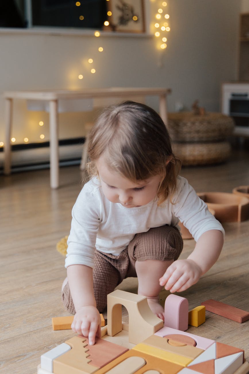 Toddler playing with wooden shapes for 20 Fun, Low-Stress Toddler Activities at Home (Easy Ideas That Actually Work) post.