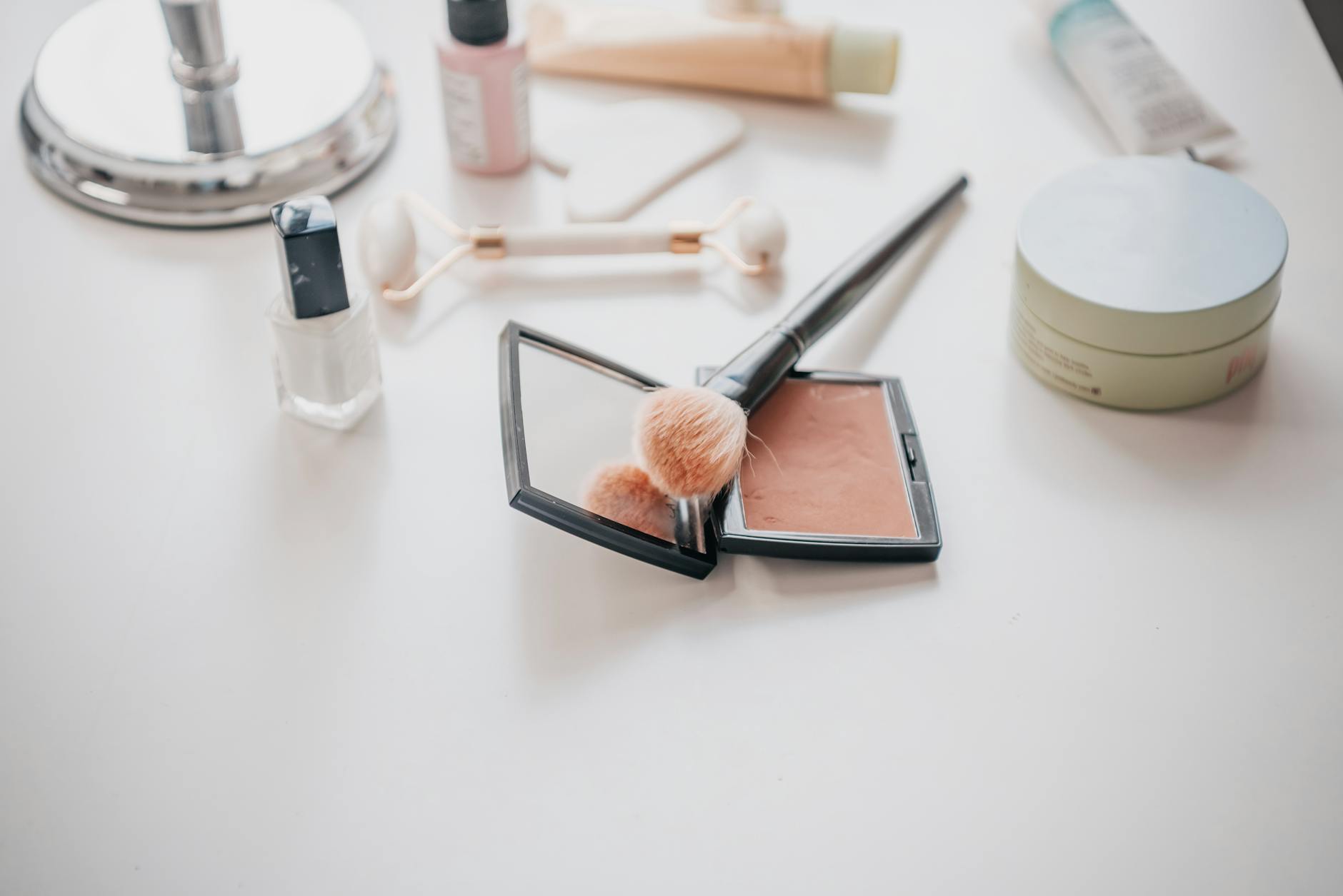 Make up and brushes on a counter ready for use for My Go-To 10 Minute Summer Makeup Routine (Quick, Fresh & Mum-Friendly) post.