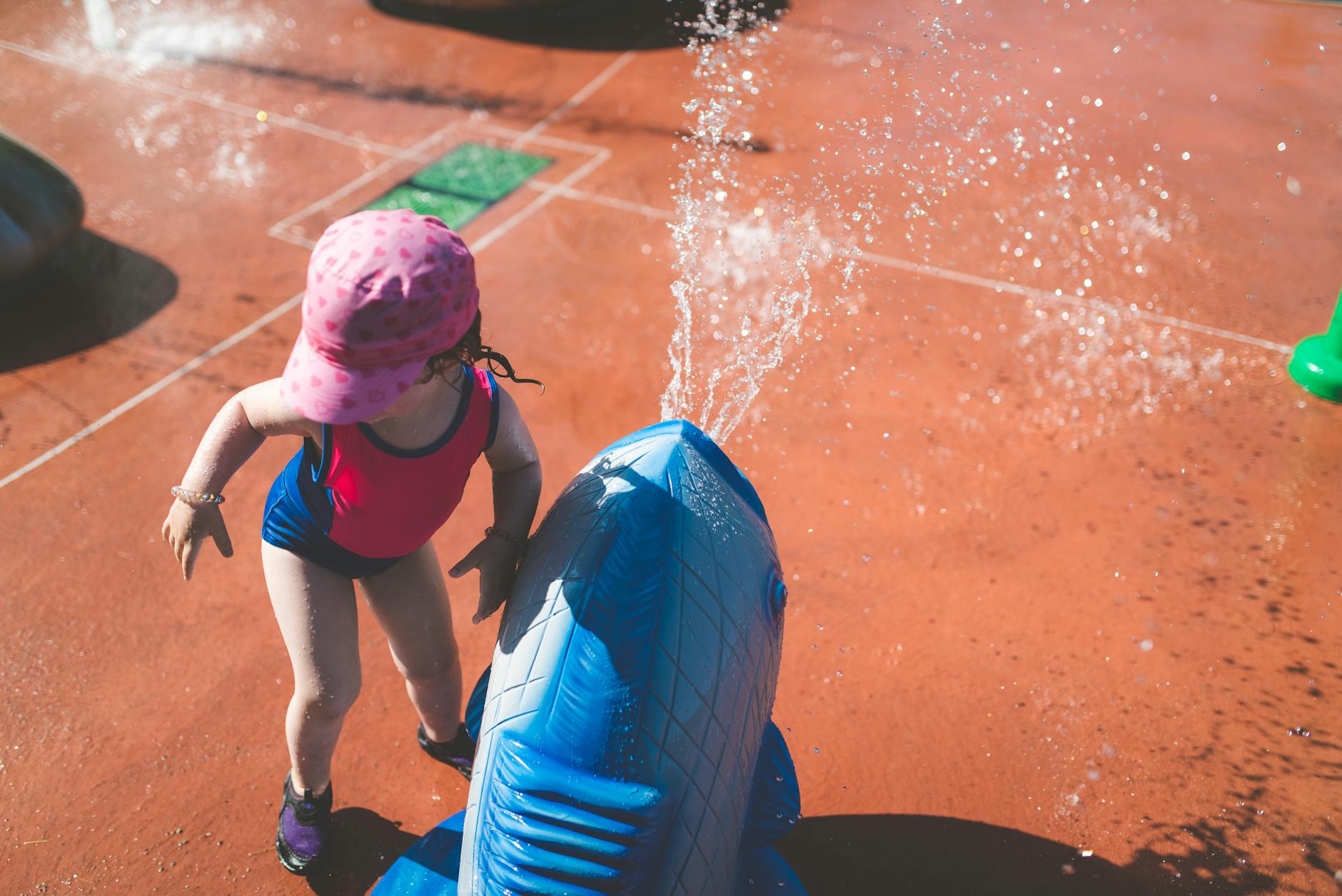 Toddler with wterplay for How to Keep Toddlers Cool and Happy During Heatwaves (Real-Life Tips That Actually Work) post.